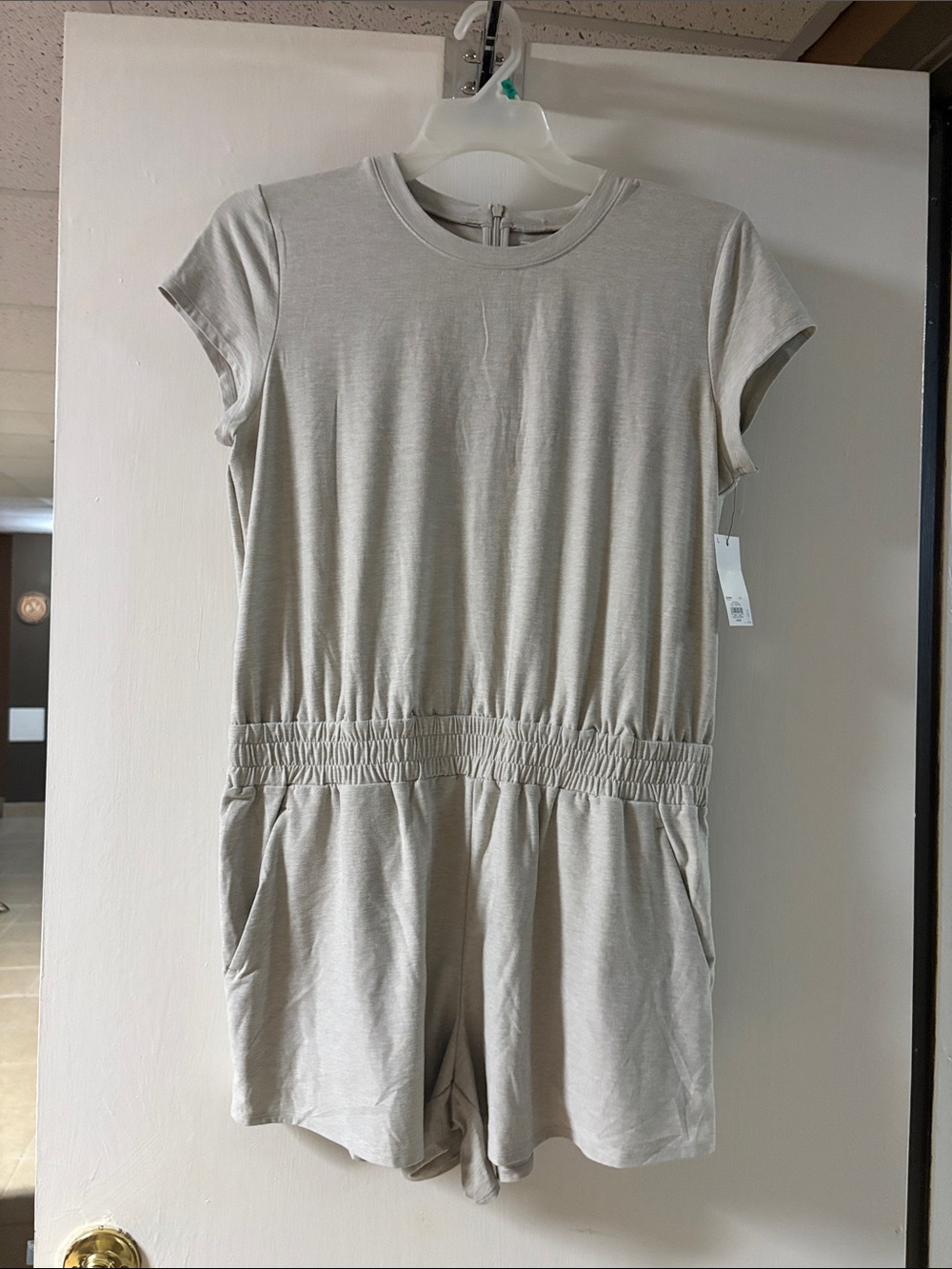 NWT FLX women’s romper size lg color ivory silk. Zips in back.